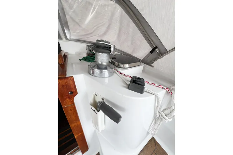 Slide: The Image of Deck equipment on a 1984 Trintella 42 sailboat, featuring winch and ropes. - 14