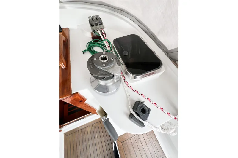 Slide: The Image of Deck equipment on a 1984 Trintella 42 sailboat, featuring winch and ropes. - 15