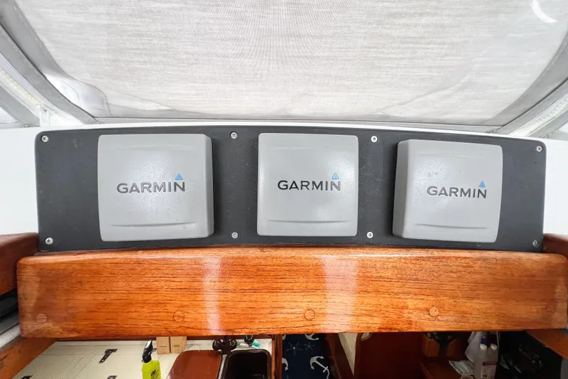 Slide: The Image of Garmin navigation equipment on 1984 Trintella 42 yacht, mounted on wooden panel. - 18