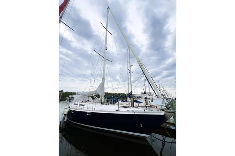 Slide: The Image of 1984 Trintella 42 sailboat docked under cloudy sky. - 2