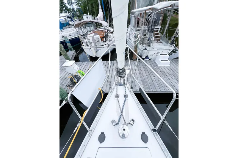 Slide: The Image of Bow view of 1984 Trintella 42 sailboat docked at a marina. - 21