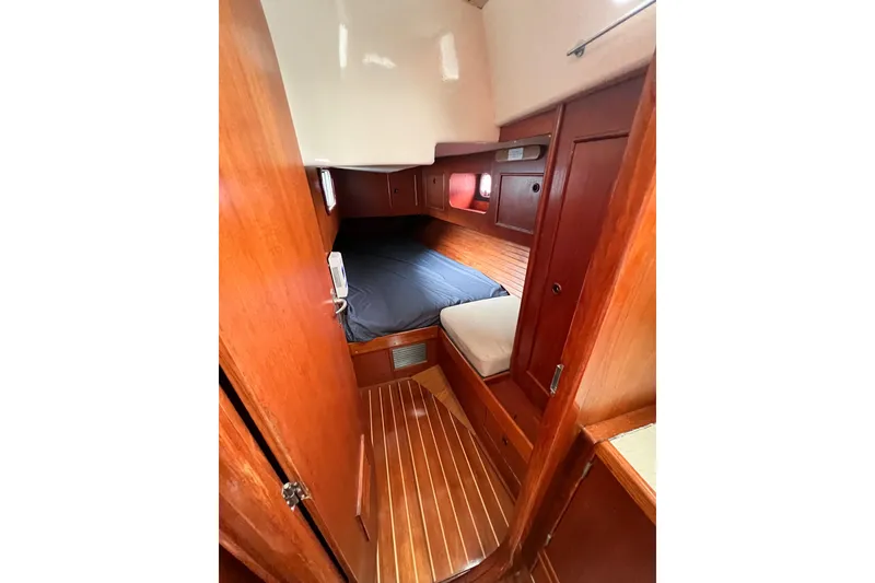 Slide: The Image of Cozy cabin interior of 1984 Trintella 42 sailboat with wooden finish. - 22