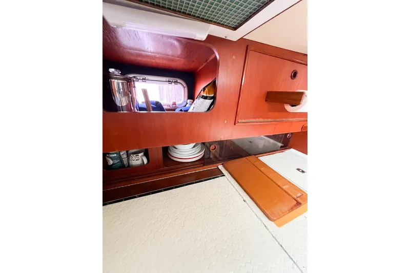 Slide: The Image of Interior of 1984 Trintella 42 yacht with wooden cabinetry and kitchenware. - 23