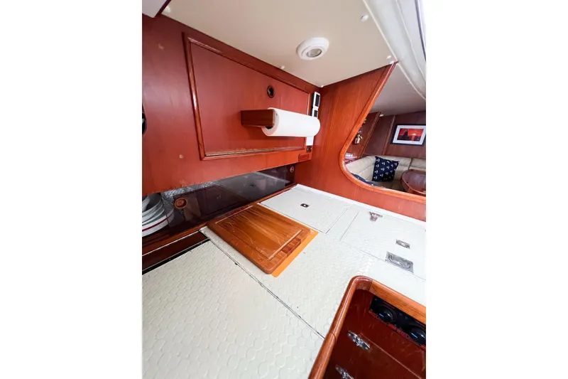 Slide: The Image of Interior of 1984 Trintella 42 yacht with wooden cabinetry and cozy seating area. - 24