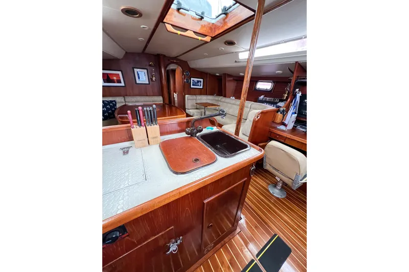 Slide: The Image of Interior of 1984 Trintella 42 yacht with wooden finishes and cozy seating area. - 27