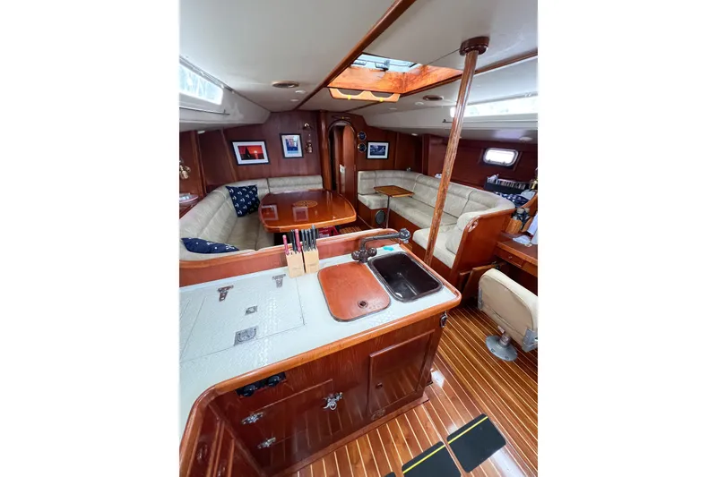 Slide: The Image of Interior of 1984 Trintella 42 yacht with wooden finishes and cozy seating area. - 28