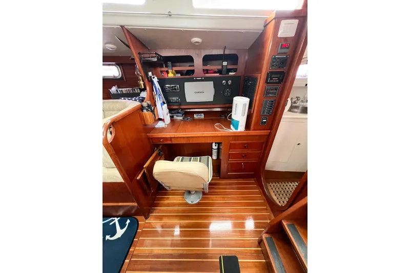 Slide: The Image of 1984 Trintella 42 yacht interior with navigation station and wooden flooring. - 29