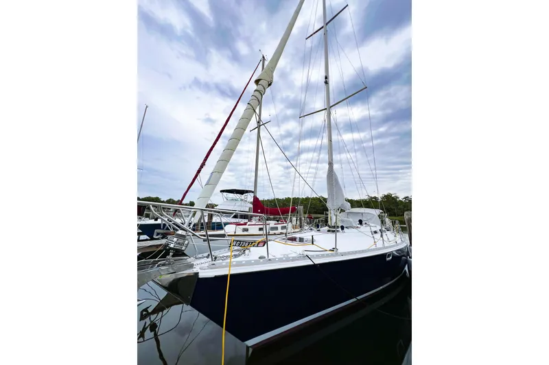 Slide: The Image of 1984 Trintella 42 sailboat docked under cloudy sky. - 3