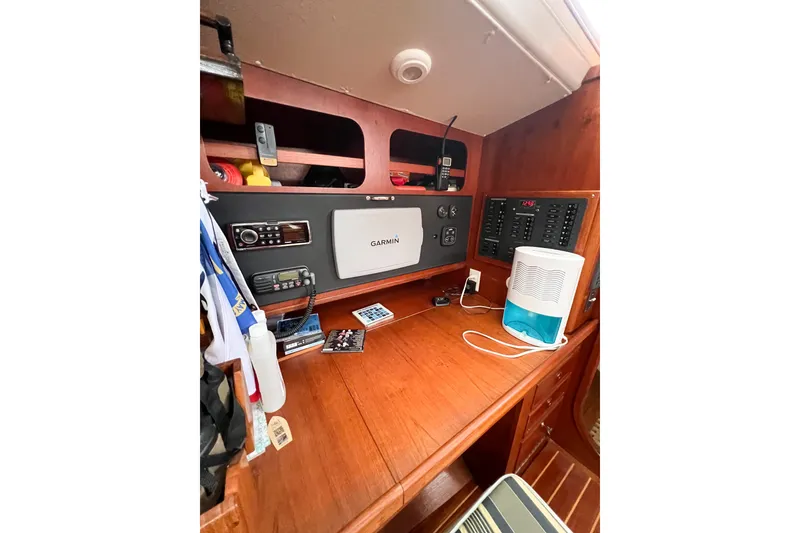 Slide: The Image of Navigation station on 1984 Trintella 42 yacht with Garmin equipment and control panel. - 31