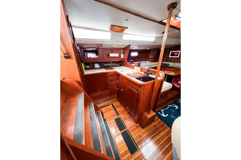 Slide: The Image of Interior of 1984 Trintella 42 sailboat with wooden cabinetry and nautical decor. - 34