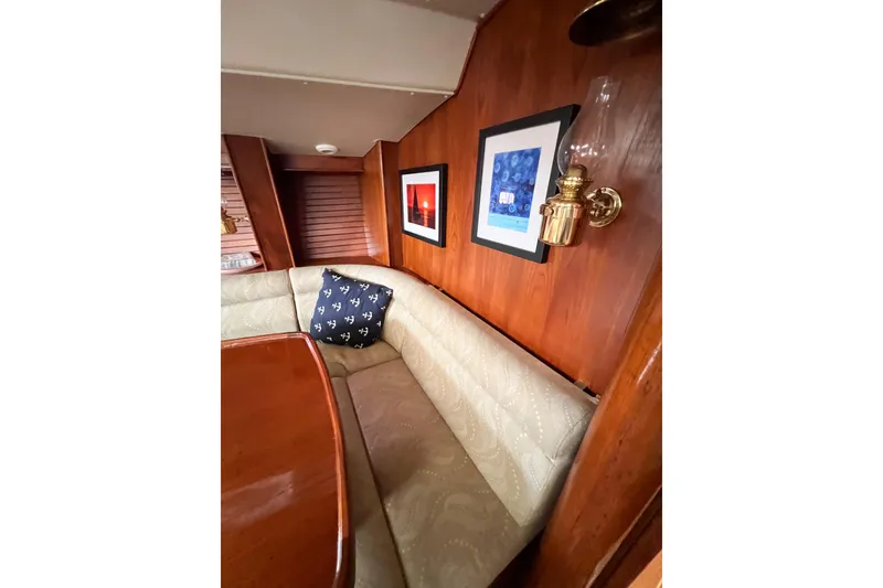 Slide: The Image of Cozy interior of 1984 Trintella 42 yacht with cushioned seating and framed artwork. - 37