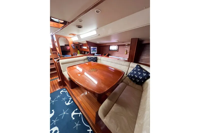 Slide: The Image of Luxurious 1984 Trintella 42 yacht interior with elegant wood finish and cozy seating area. - 38