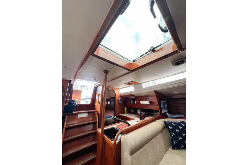 Slide: The Image of Interior of 1984 Trintella 42 sailboat, featuring wooden finishes and a skylight. - 41