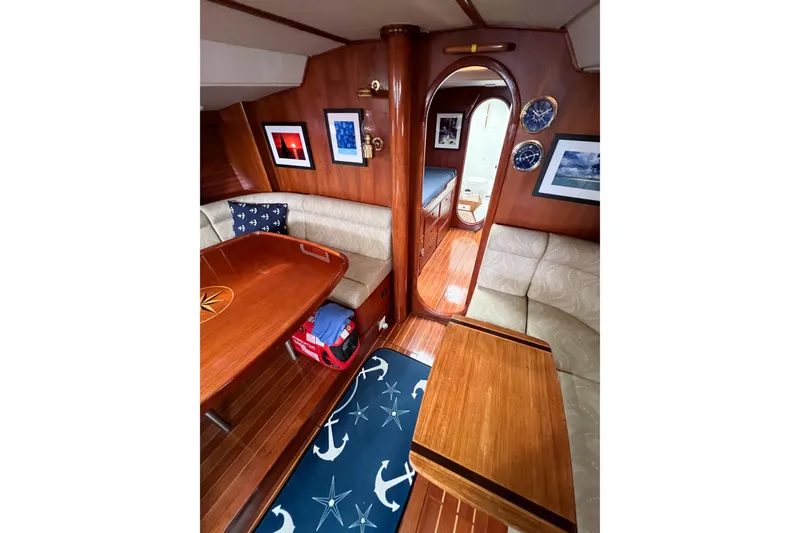 Slide: The Image of 1984 Trintella 42 yacht interior with wooden decor, cozy seating, and nautical-themed accents. - 42