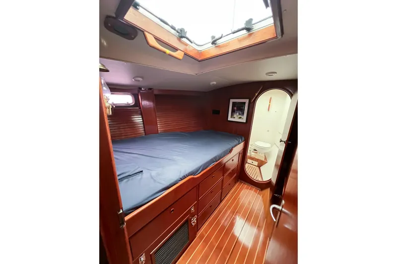 Slide: The Image of Luxurious 1984 Trintella 42 yacht cabin with wooden interior and cozy bed. - 44