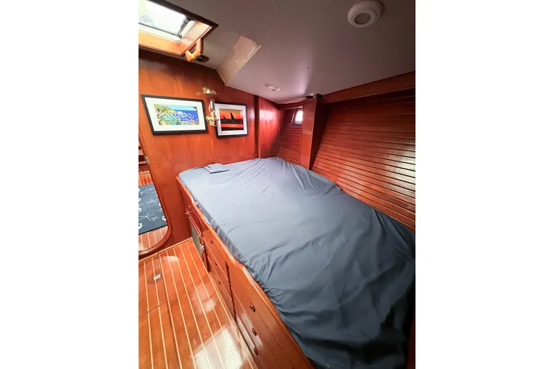 Slide: The Image of Cozy cabin interior of 1984 Trintella 42 yacht with wooden finish and artwork. - 47