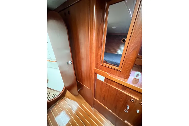 Slide: The Image of Interior of 1984 Trintella 42 yacht with wooden cabinetry and mirror. - 48