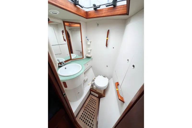 Slide: The Image of Bathroom interior of 1984 Trintella 42 yacht with sink, toilet, and mirror. - 49