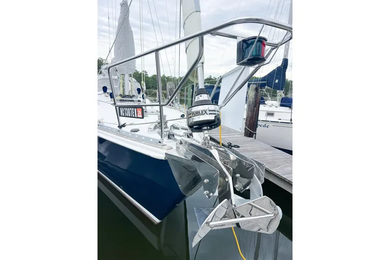 Slide: The Image of 1984 Trintella 42 sailboat docked, featuring sleek design and polished anchor. - 5