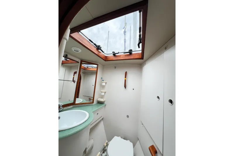 Slide: The Image of 1984 Trintella 42 yacht bathroom with skylight, mirror, and sink. - 50