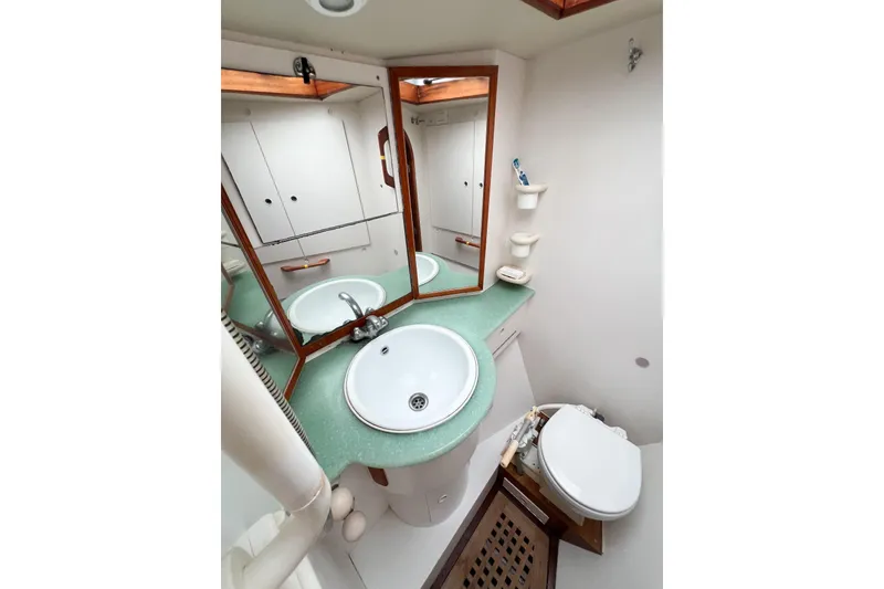 Slide: The Image of Bathroom interior of 1984 Trintella 42 yacht with sink, mirror, and toilet. - 51
