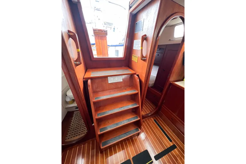 Slide: The Image of Interior of 1984 Trintella 42 sailboat with wooden stairs and cabin entrance. - 54