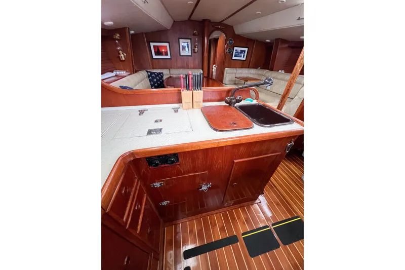 Slide: The Image of Interior of 1984 Trintella 42 yacht with wooden cabinetry and cozy seating area. - 55
