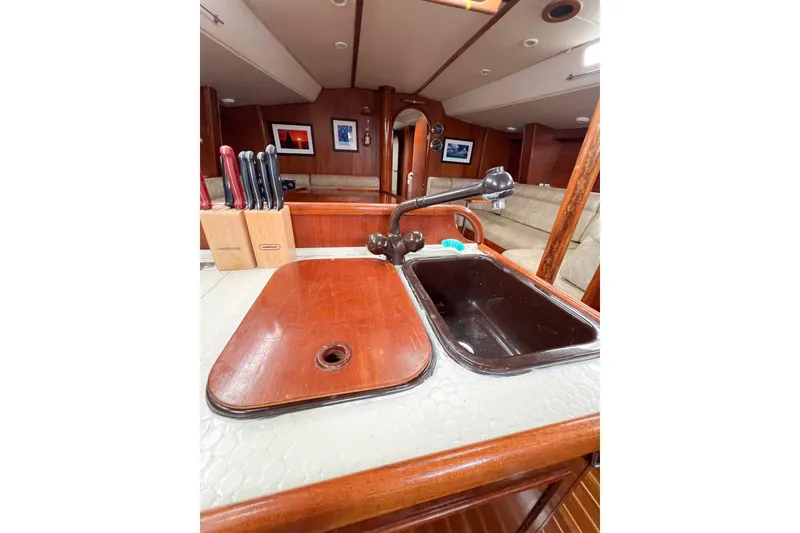 Slide: The Image of 1984 Trintella 42 yacht interior with sink, wooden countertop, and knife set. - 56