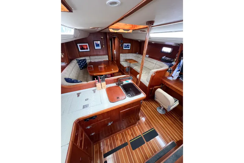 Slide: The Image of Luxurious 1984 Trintella 42 yacht interior with wooden finishes and cozy seating area. - 60