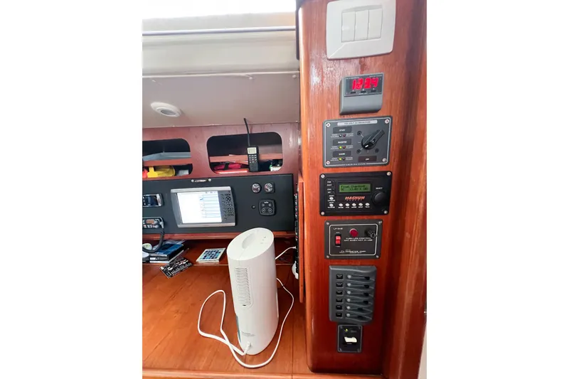 Slide: The Image of Control panel and navigation equipment inside a 1984 Trintella 42 sailboat cabin. - 62