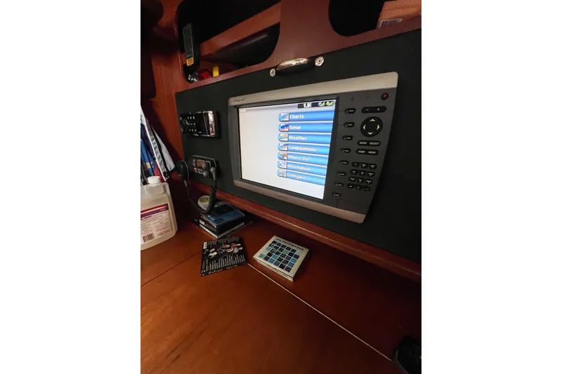 Slide: The Image of Navigation equipment on a 1984 Trintella 42 yacht, featuring a multifunction display. - 63