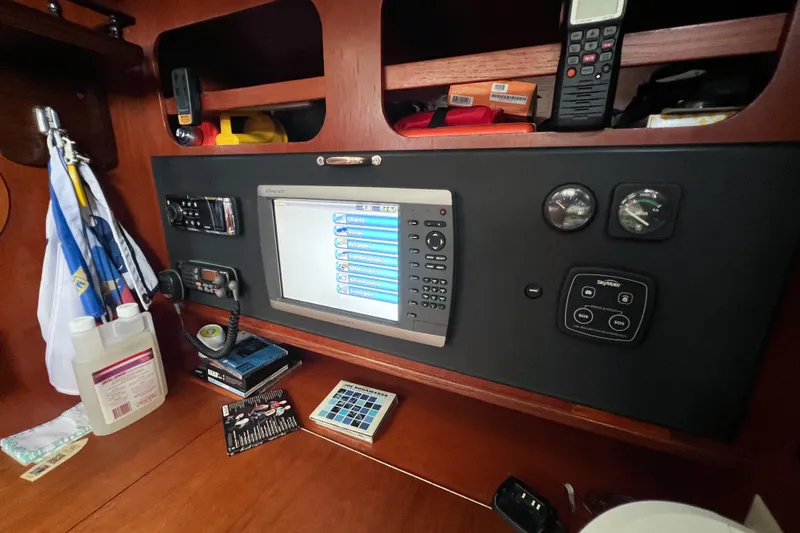 Slide: The Image of Navigation equipment on a 1984 Trintella 42 sailboat, featuring control panel and communication devices. - 64