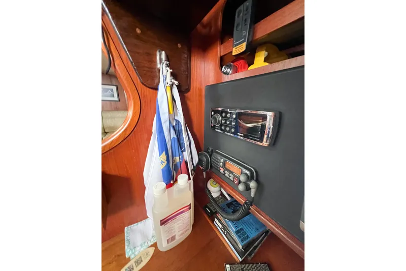 Slide: The Image of Interior of 1984 Trintella 42 yacht with radio equipment and nautical flags. - 65