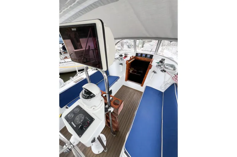 Slide: The Image of Cockpit of 1984 Trintella 42 sailboat with navigation equipment and blue seating. - 72