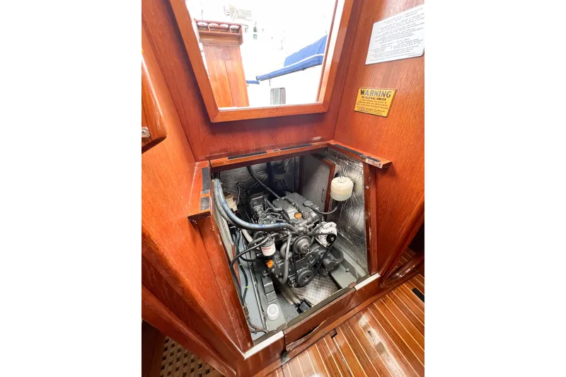 Slide: The Image of Engine compartment of 1984 Trintella 42 sailboat, showcasing detailed mechanical components. - 74