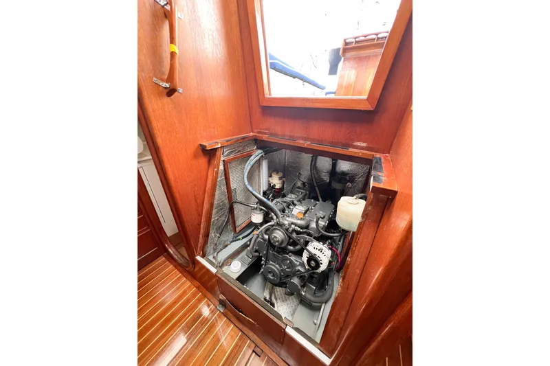 Slide: The Image of Engine compartment of 1984 Trintella 42 sailboat with wooden interior paneling. - 77