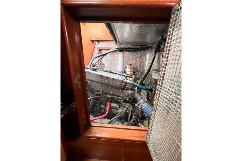 Slide: The Image of Engine compartment of a 1984 Trintella 42 sailboat, featuring a Yanmar engine. - 78
