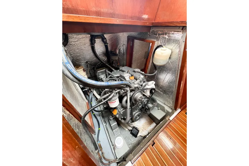 Slide: The Image of Engine compartment of a 1984 Trintella 42 sailboat, showcasing mechanical components. - 79