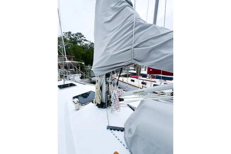 Slide: The Image of 1984 Trintella 42 sailboat deck with covered mast and rigging. - 8