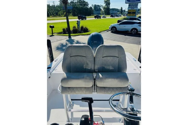 Slide: The Image of 2021 Sportsman Masters 227 Bay Boat interior with dual seats and steering wheel. - 3