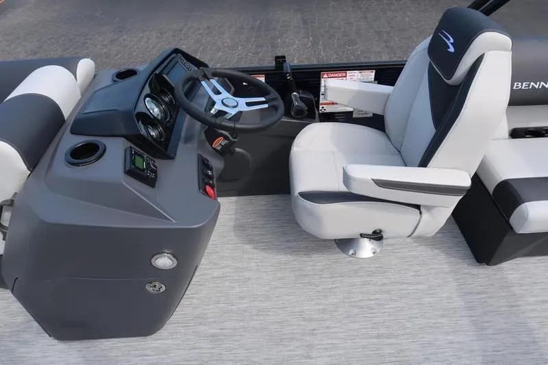 Slide: The Image of 2026 Bennington S Quad Bench 20 SSR boat interior with steering console and captain's chair. - 13