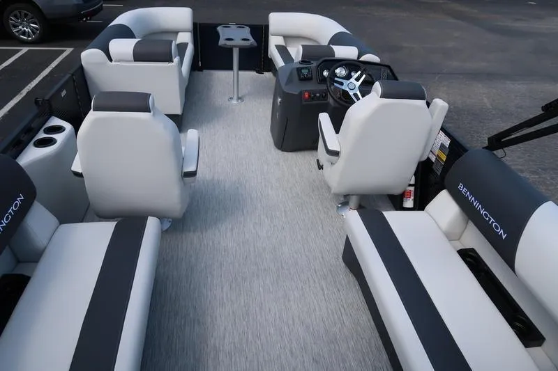 Slide: The Image of 2026 Bennington S Quad Bench 20 SSR pontoon boat interior with plush seating and modern helm. - 21