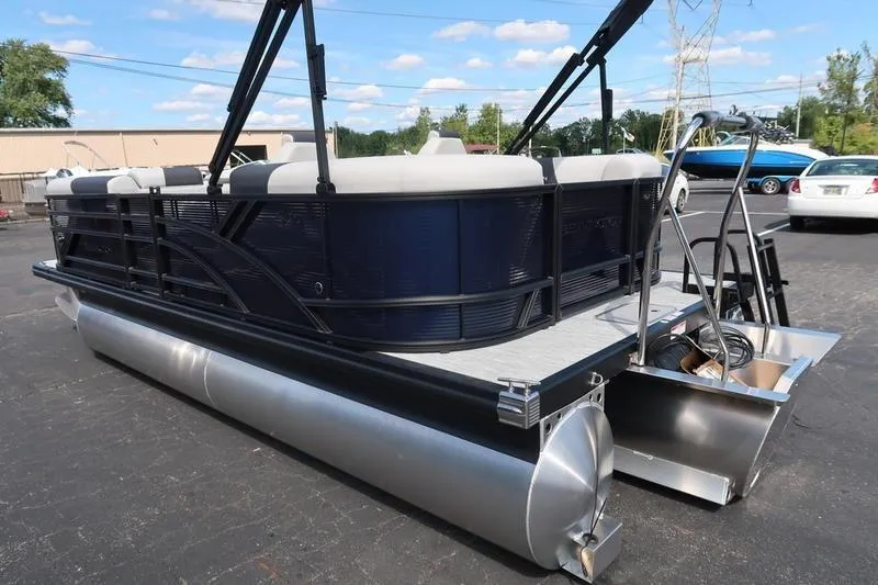 Slide: The Image of 2026 Bennington S Quad Bench 20 SSR pontoon boat, parked outdoors on a sunny day. - 6