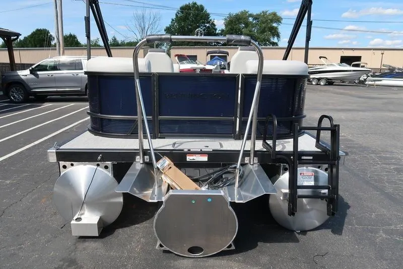 Slide: The Image of 2026 Bennington S Quad Bench 20 SSR pontoon boat, rear view in parking lot. - 7