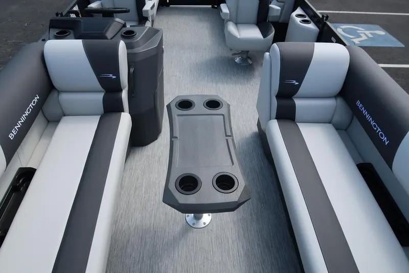 Slide: The Image of 2026 Bennington S Quad Bench 20 SSR interior with gray seating and central table. - 8