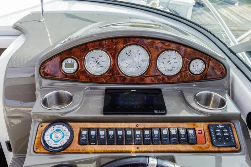 Slide: The Image of 2013 Rinker 290 Express Cruiser dashboard with gauges and controls. - 13