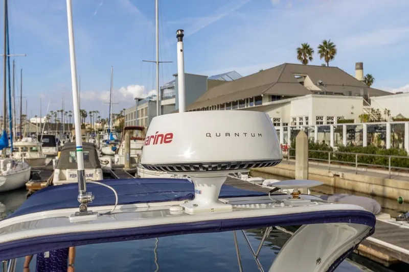 Slide: The Image of 2013 Rinker 290 Express Cruiser with Quantum radar in marina setting. - 25