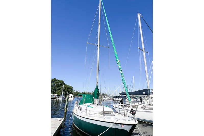 The Image of 1978 CAL 34 sailboat docked at marina under clear blue sky. - 1