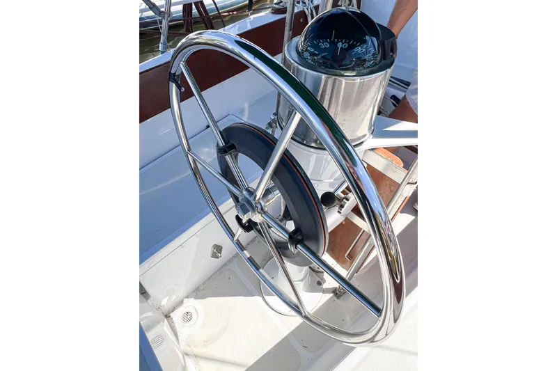 Slide: The Image of Steering wheel and compass of a 1978 CAL 34 sailboat. - 13