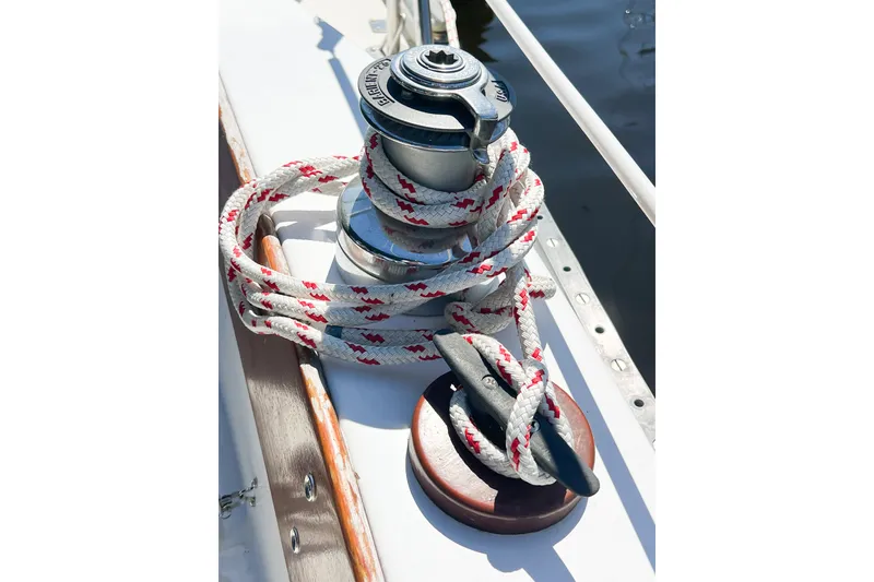 Slide: The Image of Sailboat winch with rope on a 1978 CAL 34 deck, sunlight reflecting on water. - 15